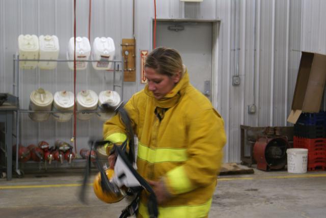 Chelsea Tremblay removes her SCBA following an exhausting search and rescue drill at the Paul Smiths Fire Station 10/16/2010